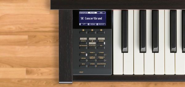 Kawai digital piano is sitting on top of a wooden desk referring to Kawai CN37 beginner keyboard pianos Calgary store